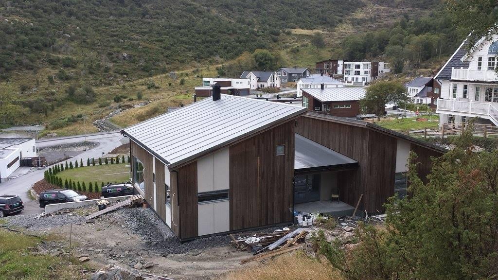 A new house with a grey profiled metal roof