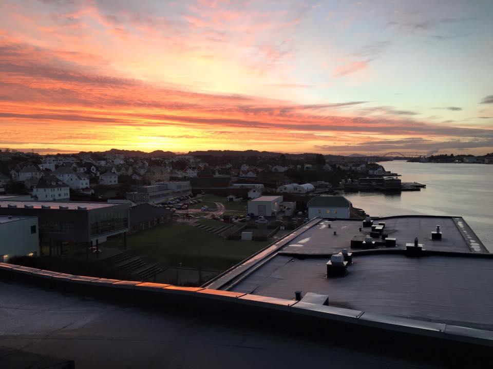 A flat membrane roof over the town at sunset